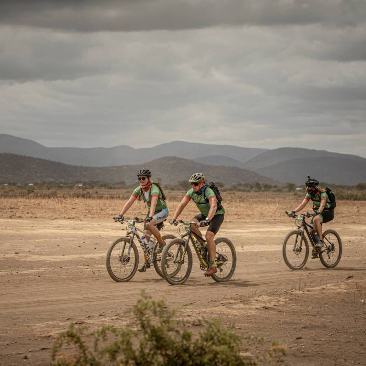 Africa Classic deelnemers fietst over een weg langs bosjes